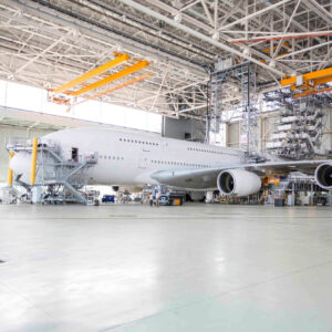 Side view of an A380 in a hangar for maintenance